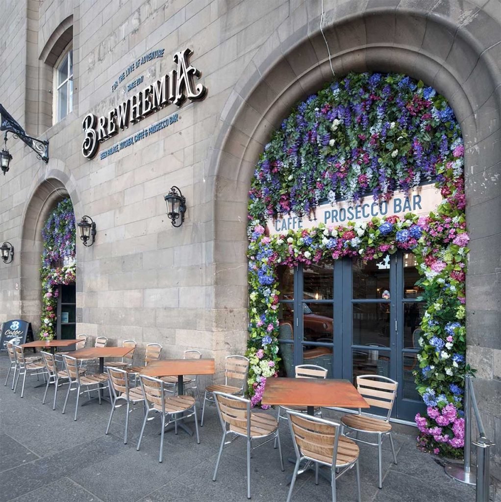 Brewhemia’s exterior archways bursting with artificial roses, wisteria and assorted greenery for their pavement café